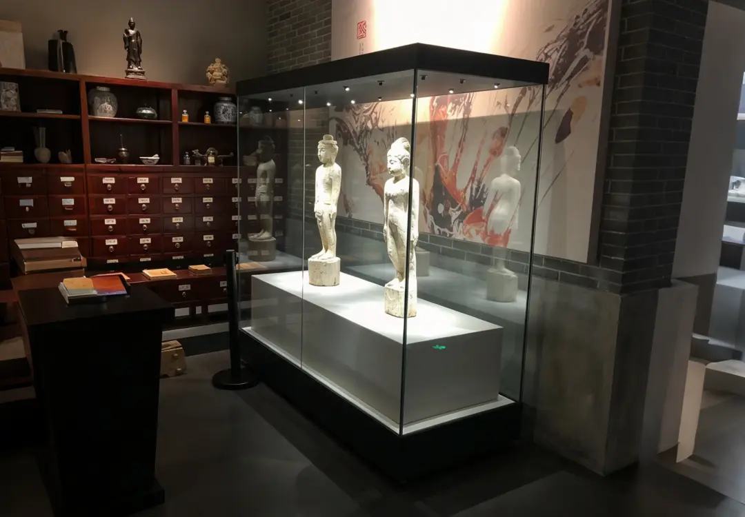 Museum freestanding display case for stone sculpture exhibits with LED lighting inside glass cabinet