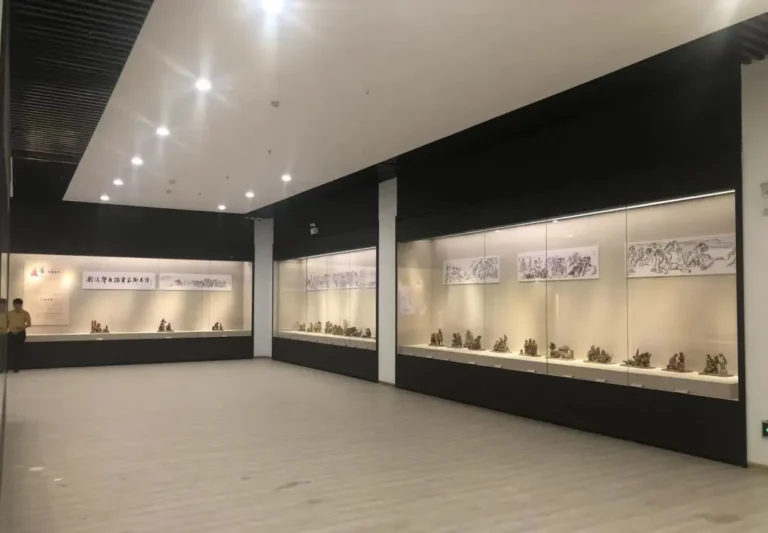 Series of museum wall mounted display cases for sculpture and drawing exhibits in spacious museum gallery